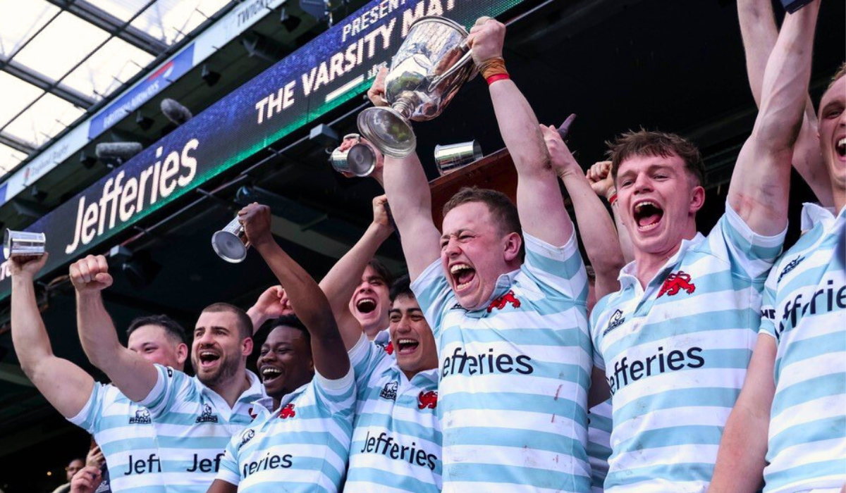 Cambridge University RUFC men's team holding trophy celebrating at Twickenham