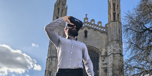 Dr Chris Macdonald wearing device mount in front of Kings College Chapel