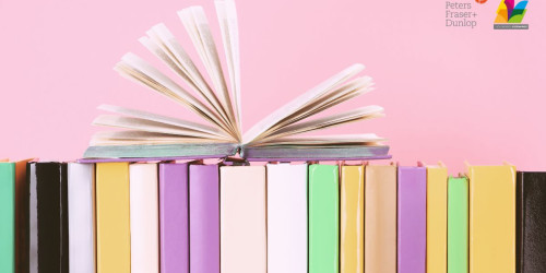 Stack of books on pink background