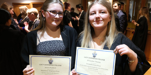 Jessica and Ell holding prize certificates